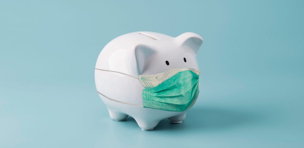 White piggy bank saving wearing surgical mask on blue background for money saving for investment and retirement in the future concept.